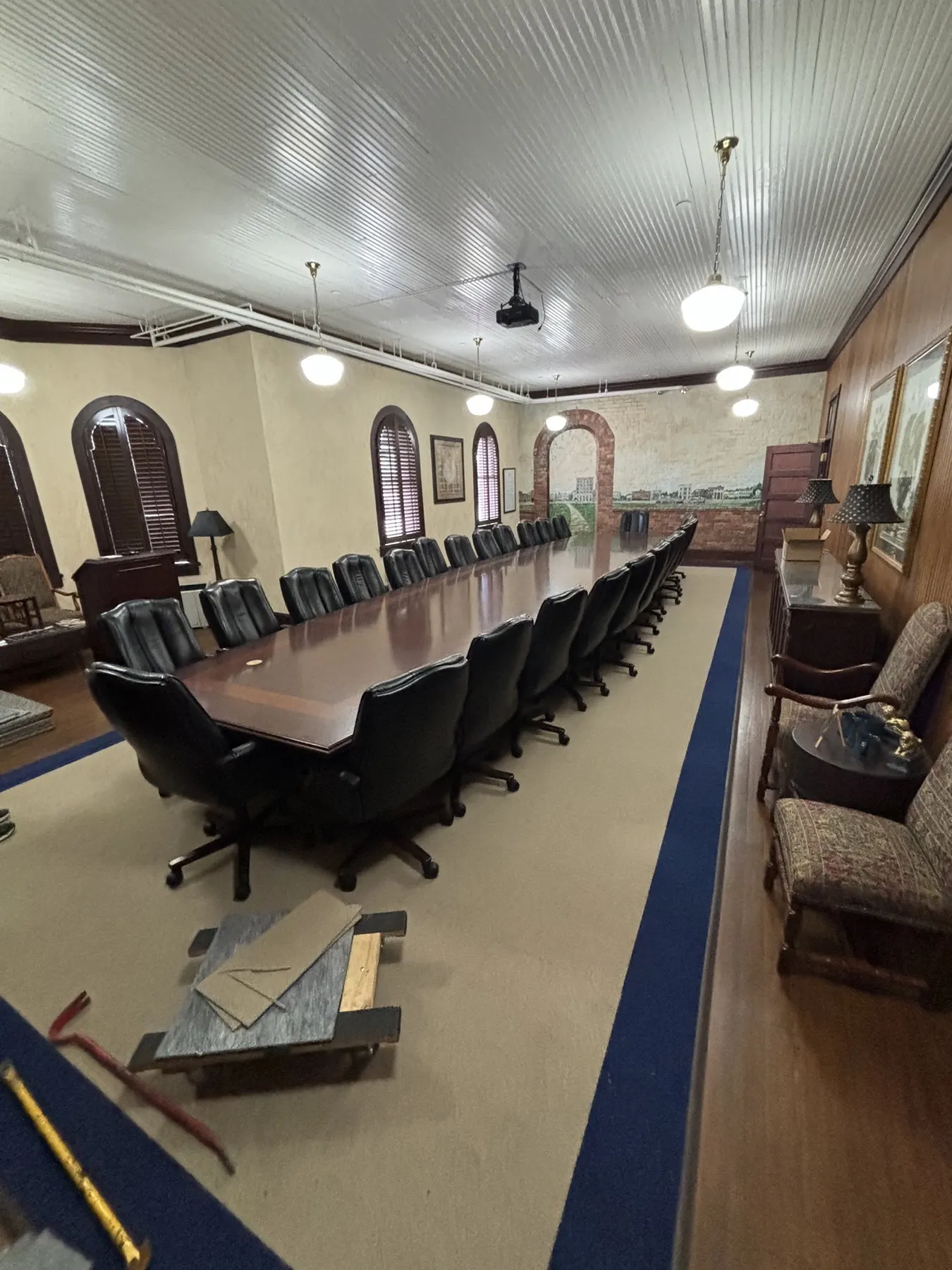The same boardroom with new carpet inside a contrasting navy border around the conference table