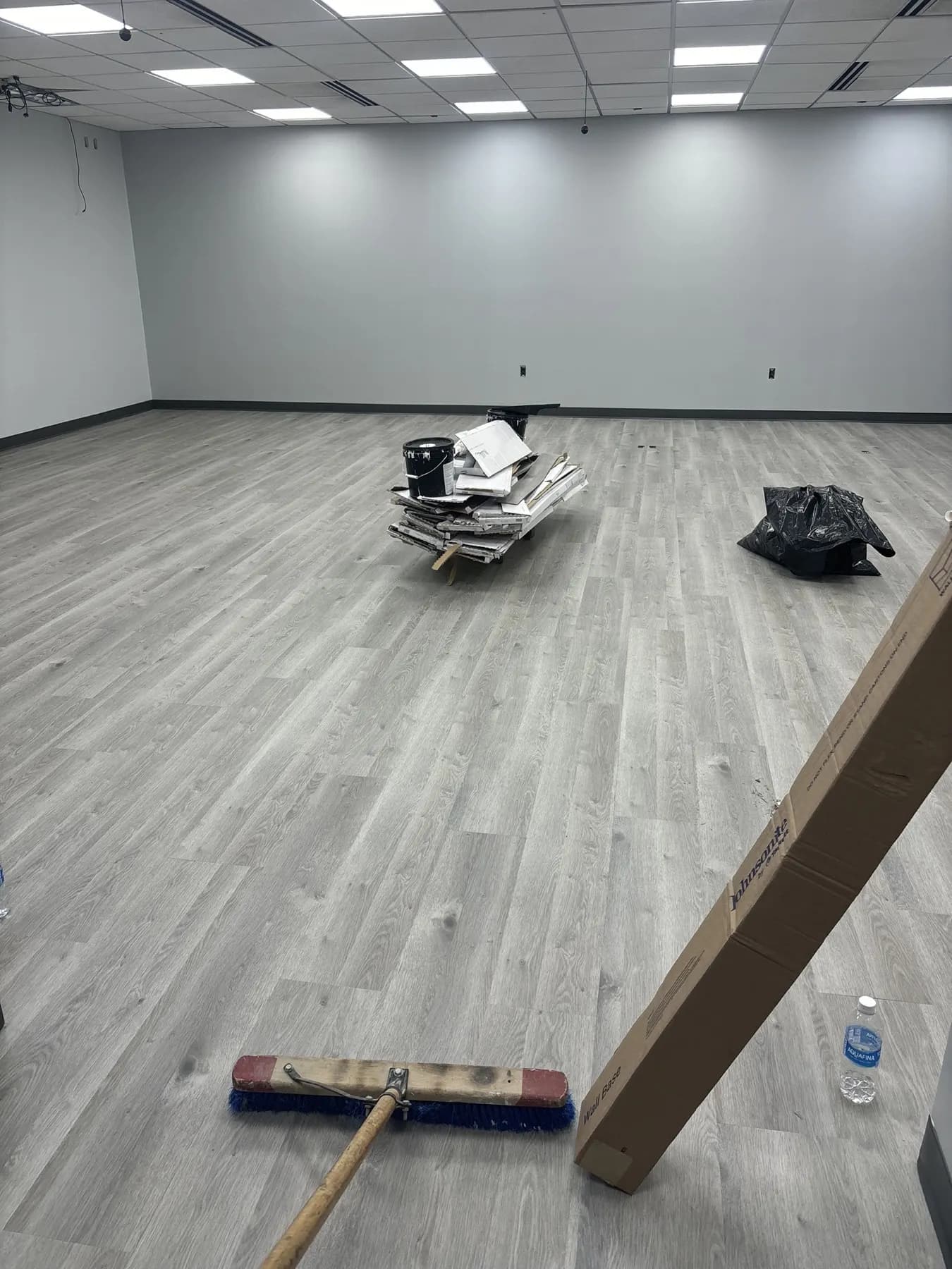 The finished training room in continuous gray wood-look luxury vinyl plank